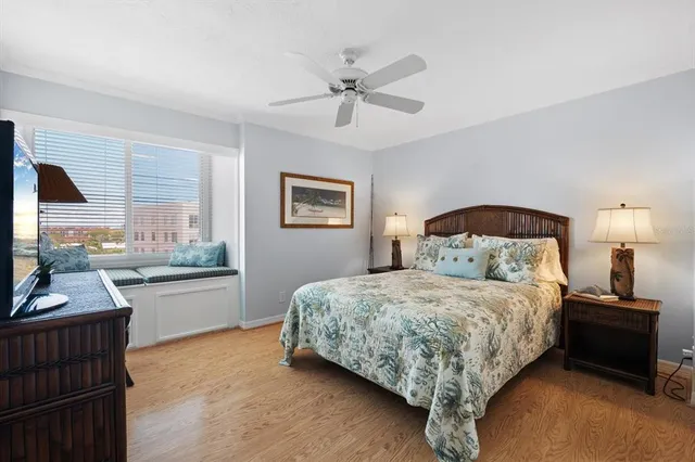 a bedroom with a bed and a television