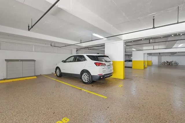 a utility room with dryer and cars