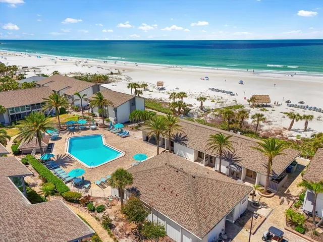an aerial view of a house with a yard and lake view