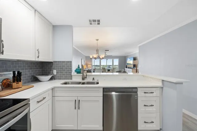 a kitchen with stainless steel appliances granite countertop a refrigerator sink and cabinets