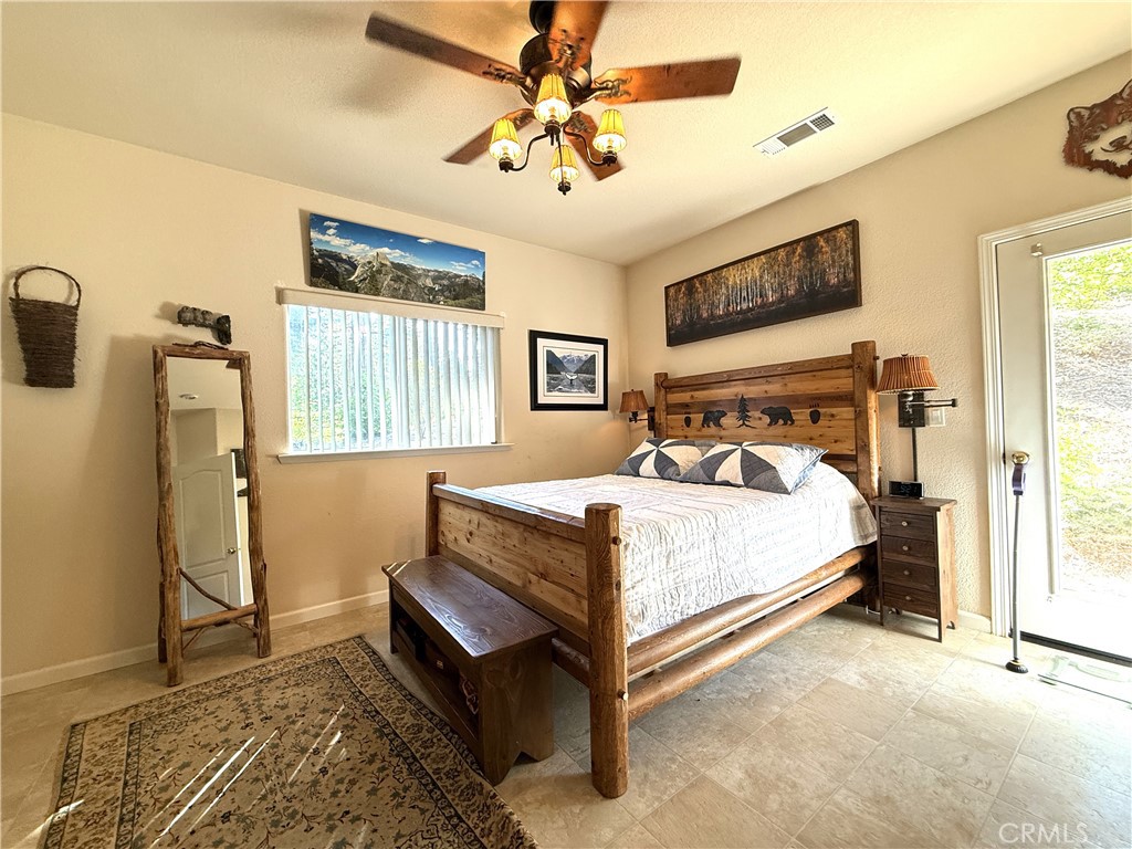3502 Comet Mine Mariposa, CA 95338 - Photo 31 of 47 a bedroom with a bed and a chandelier