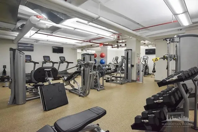 a room with gym equipment and a large window