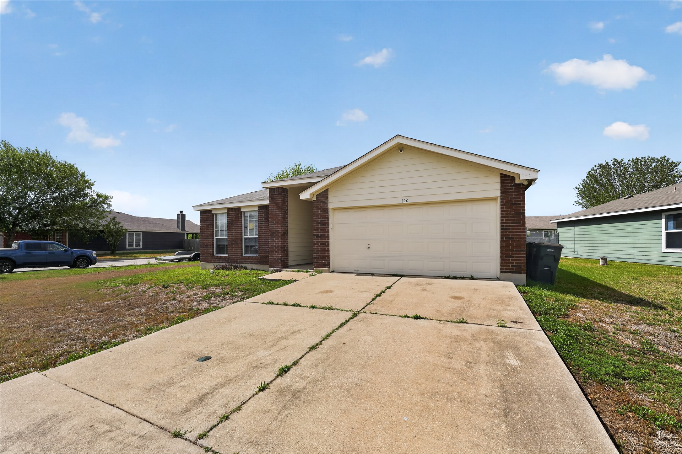 152 Eagle Drive Luling, TX 78648 - Photo 1 of 31 View of front of property with brick siding, concrete driveway, a garage, and a front yard