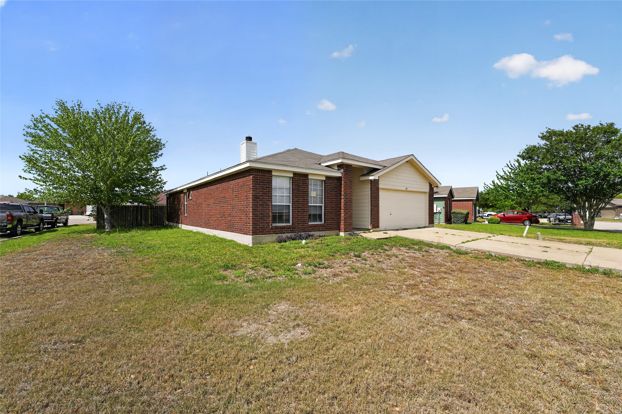 152 Eagle Drive Luling, TX 78648 - Photo 2 of 31 Single story home with brick siding, a chimney, concrete driveway, and a front lawn