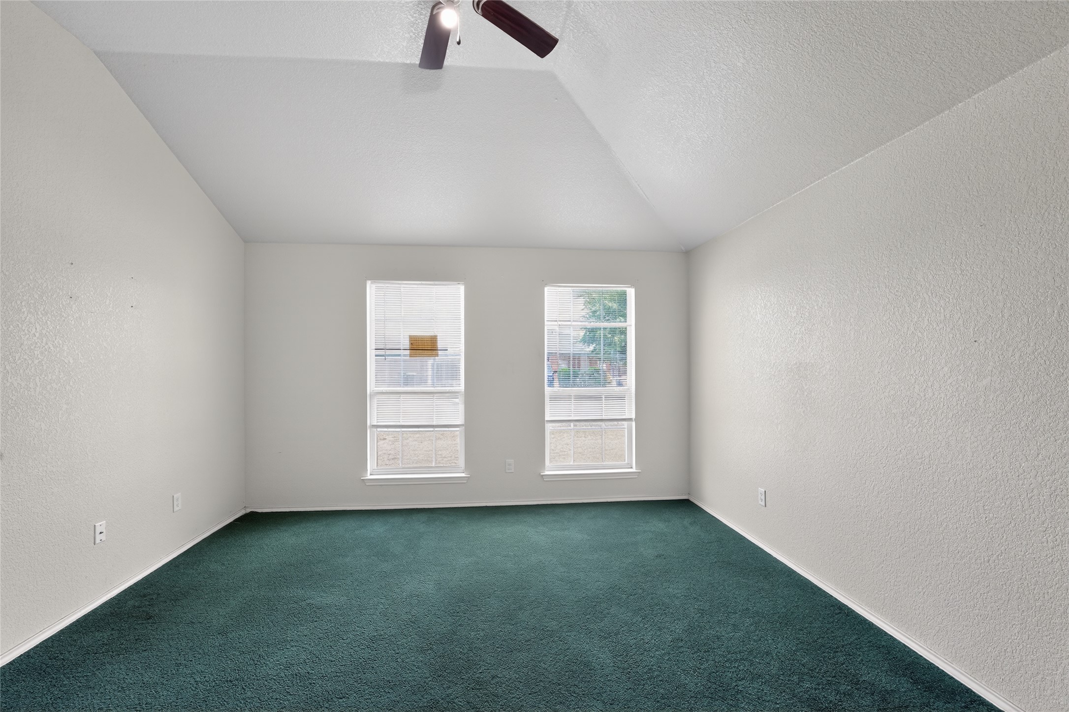 152 Eagle Drive Luling, TX 78648 - Photo 21 of 31 Carpeted spare room featuring a textured wall and ceiling fan