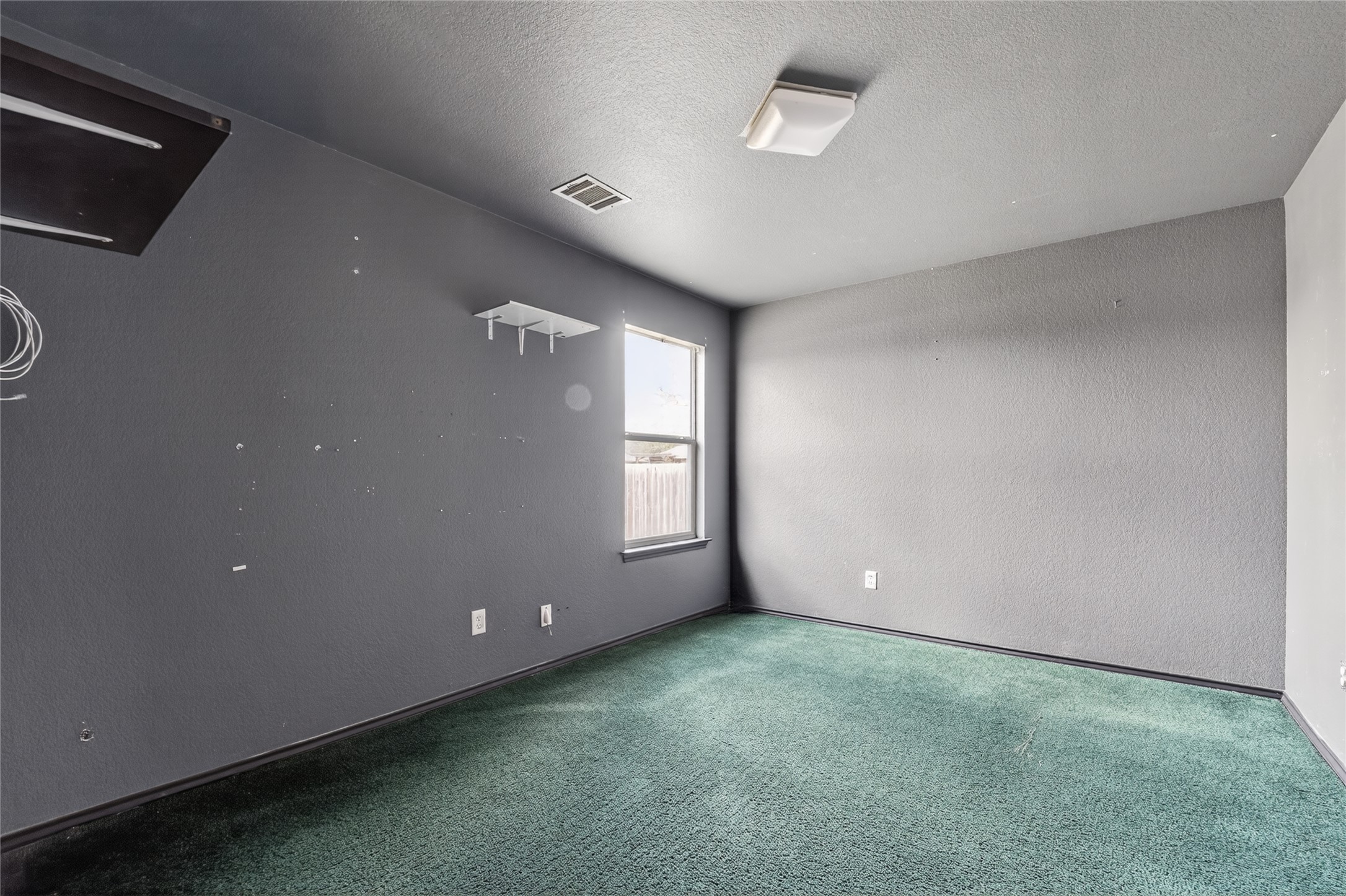 152 Eagle Drive Luling, TX 78648 - Photo 25 of 31 Spare room featuring a textured wall, a textured ceiling, and carpet floors