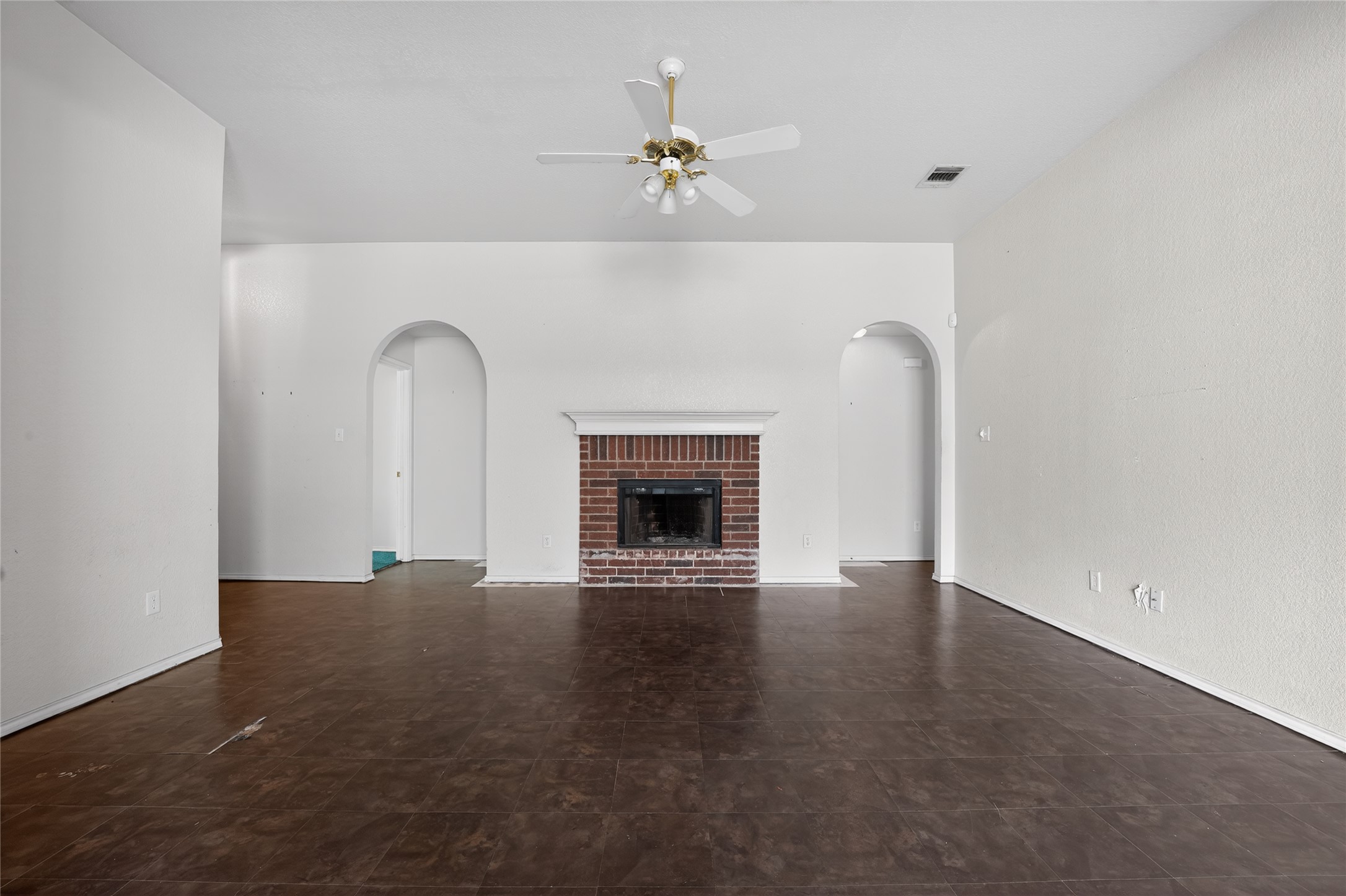 152 Eagle Drive Luling, TX 78648 - Photo 4 of 31 Unfurnished living room with a fireplace and ceiling fan