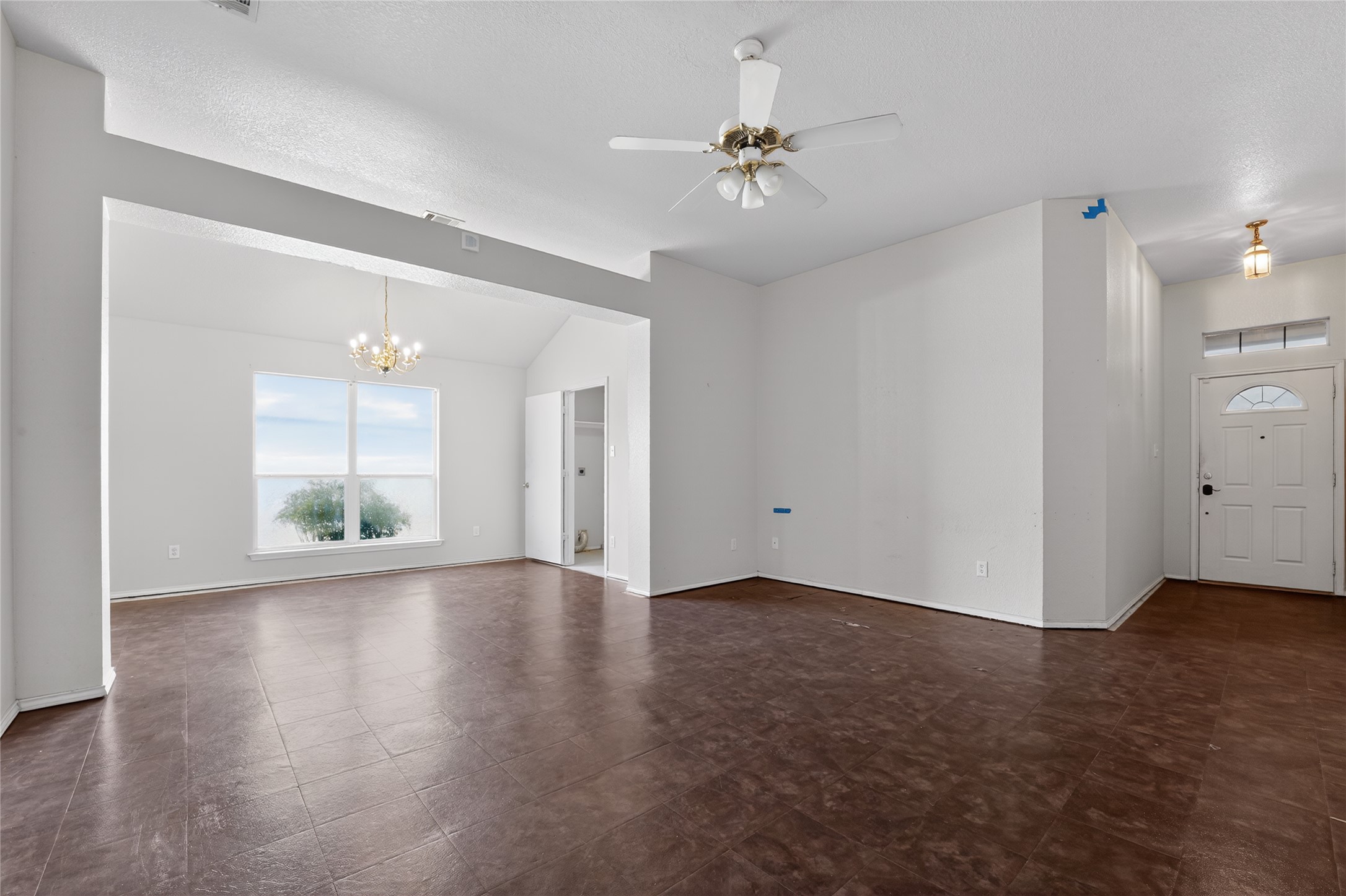 152 Eagle Drive Luling, TX 78648 - Photo 6 of 31 Unfurnished living room with ceiling fan, hanging lights, and vaulted ceiling