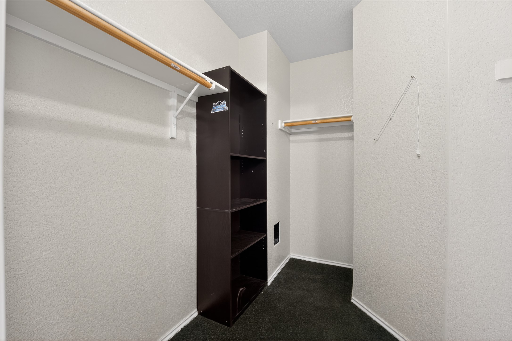 152 Eagle Drive Luling, TX 78648 - Photo 7 of 31 Walk in closet featuring dark carpet