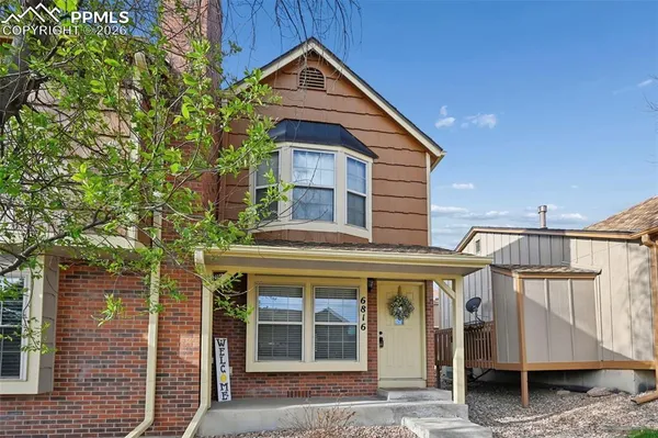 a view of a house with a yard and balcony