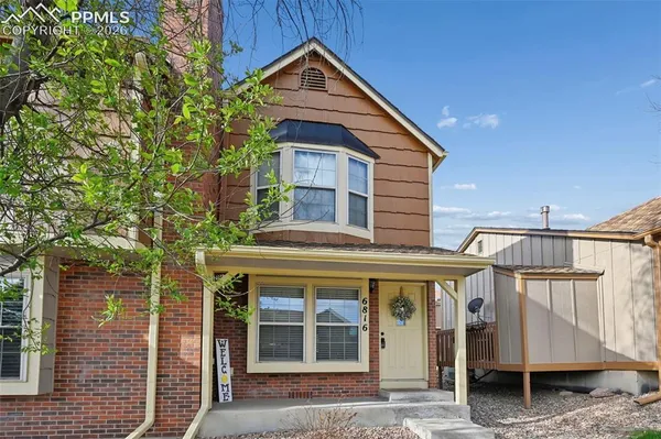 a view of a house with a yard and balcony
