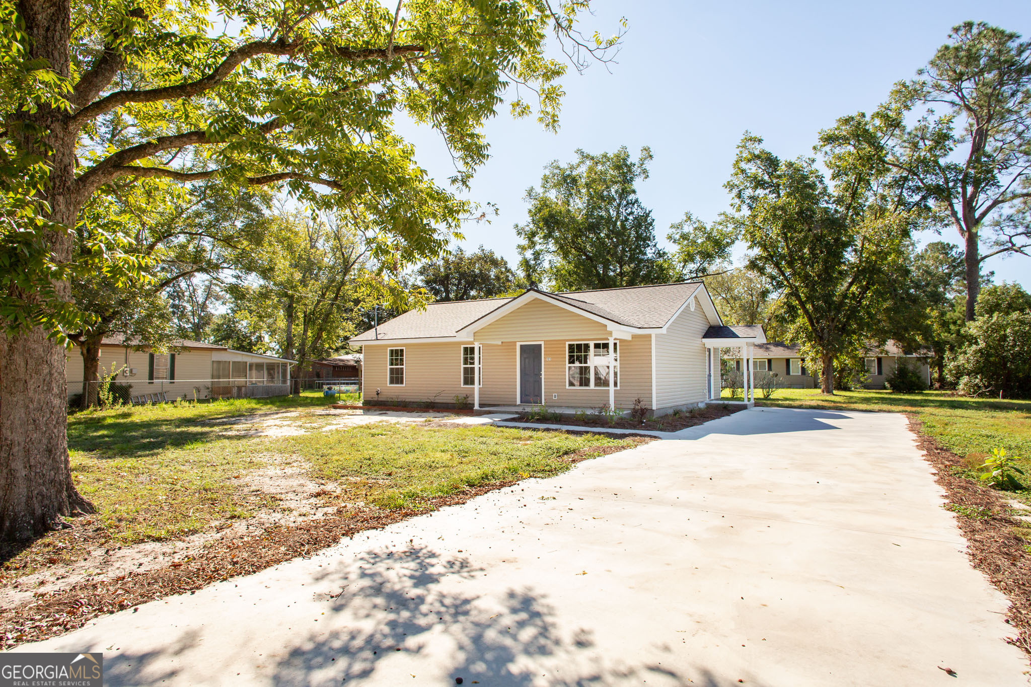 121 Union Street Waycross, GA 31501 - Photo 25 of 25 a view of a yard in front of a house with a large tree