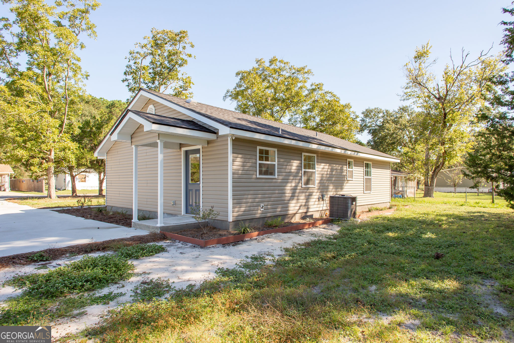 121 Union Street Waycross, GA 31501 - Photo 3 of 25 a backyard of a house with yard and outdoor seating