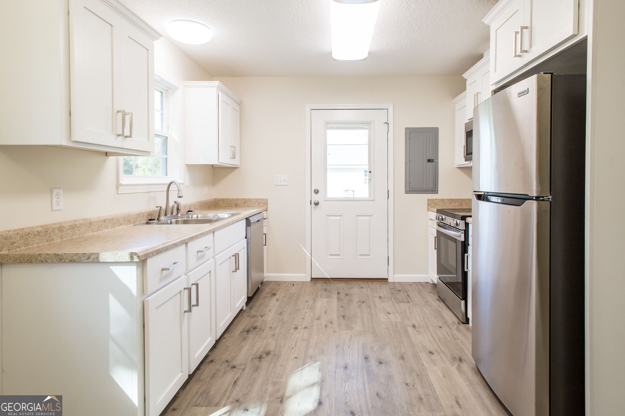 121 Union Street Waycross, GA 31501 - Photo 9 of 25 a kitchen with white cabinets and refrigerator