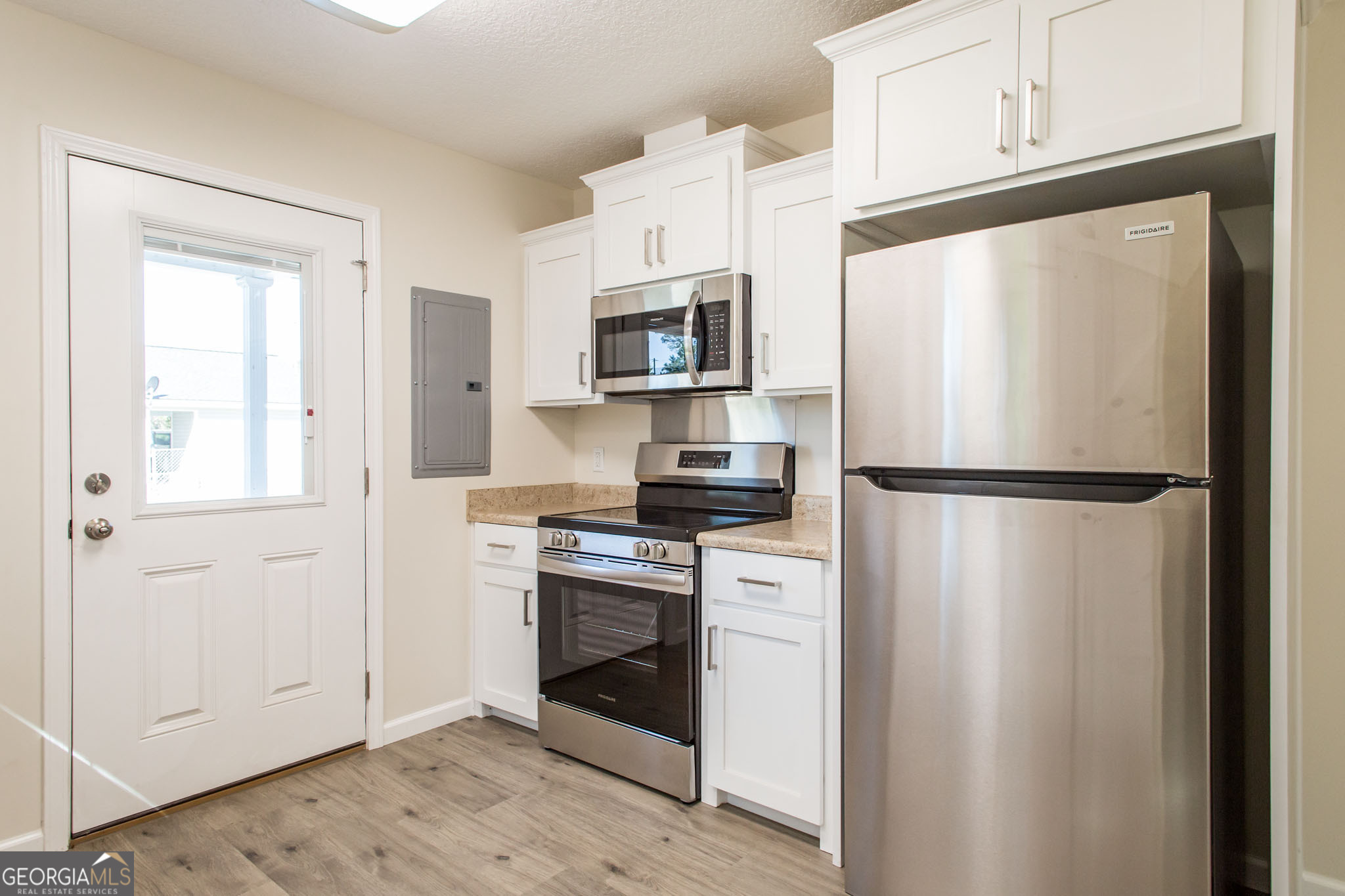 121 Union Street Waycross, GA 31501 - Photo 10 of 25 a kitchen with stainless steel appliances a refrigerator sink and microwave