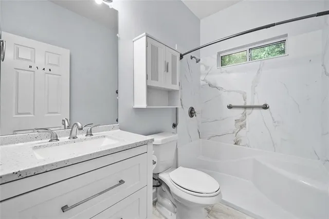 a bathroom with a sink a toilet and a bathtub