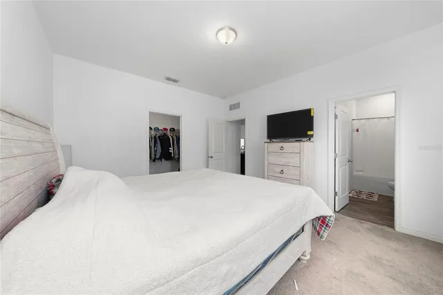 a bathroom with a granite countertop sink mirror and a toilet