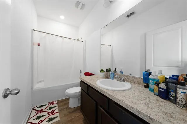 a view of walk in closet with clothes