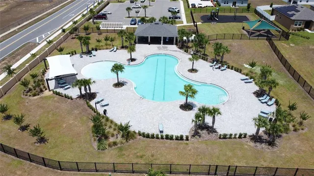 a view of a swimming pool with a yard