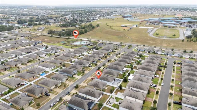 an aerial view of residential houses with outdoor space