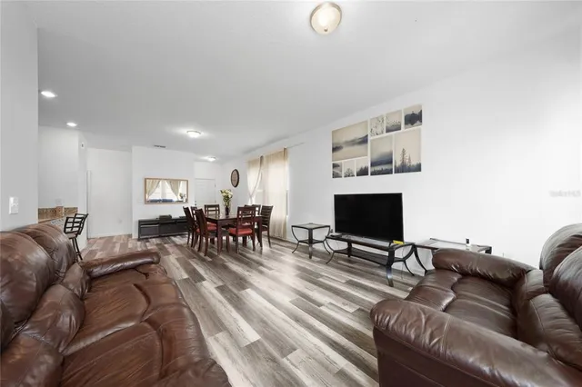 a kitchen with stainless steel appliances kitchen island granite countertop a sink and a refrigerator