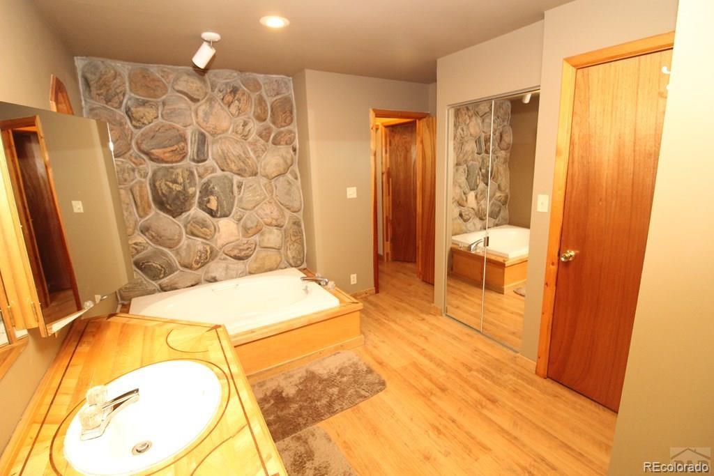 148 County Road 378, Unit 378 Rye, CO 81069 - Photo 12 of 35 a spacious bathroom with a granite countertop sink and a mirror