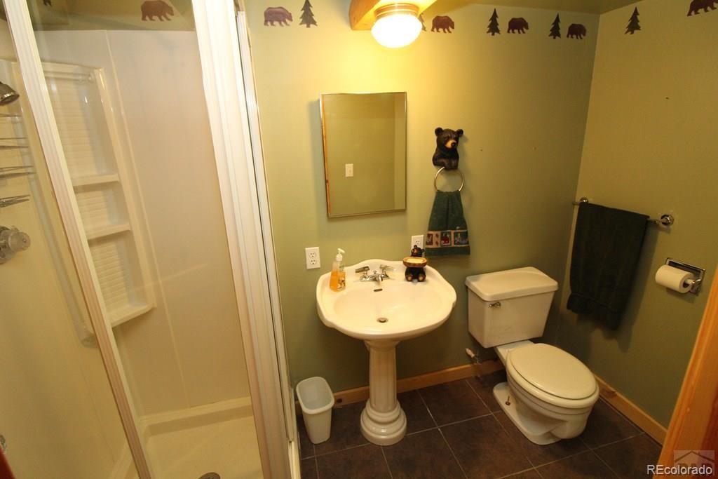 148 County Road 378, Unit 378 Rye, CO 81069 - Photo 17 of 35 a white toilet sitting next to a bathroom sink