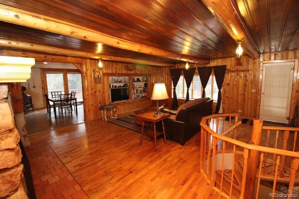 148 County Road 378, Unit 378 Rye, CO 81069 - Photo 3 of 35 a living room with furniture pool table wooden floor and windows