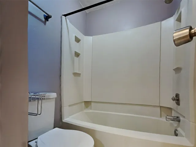 a bathroom with a shower and a toilet