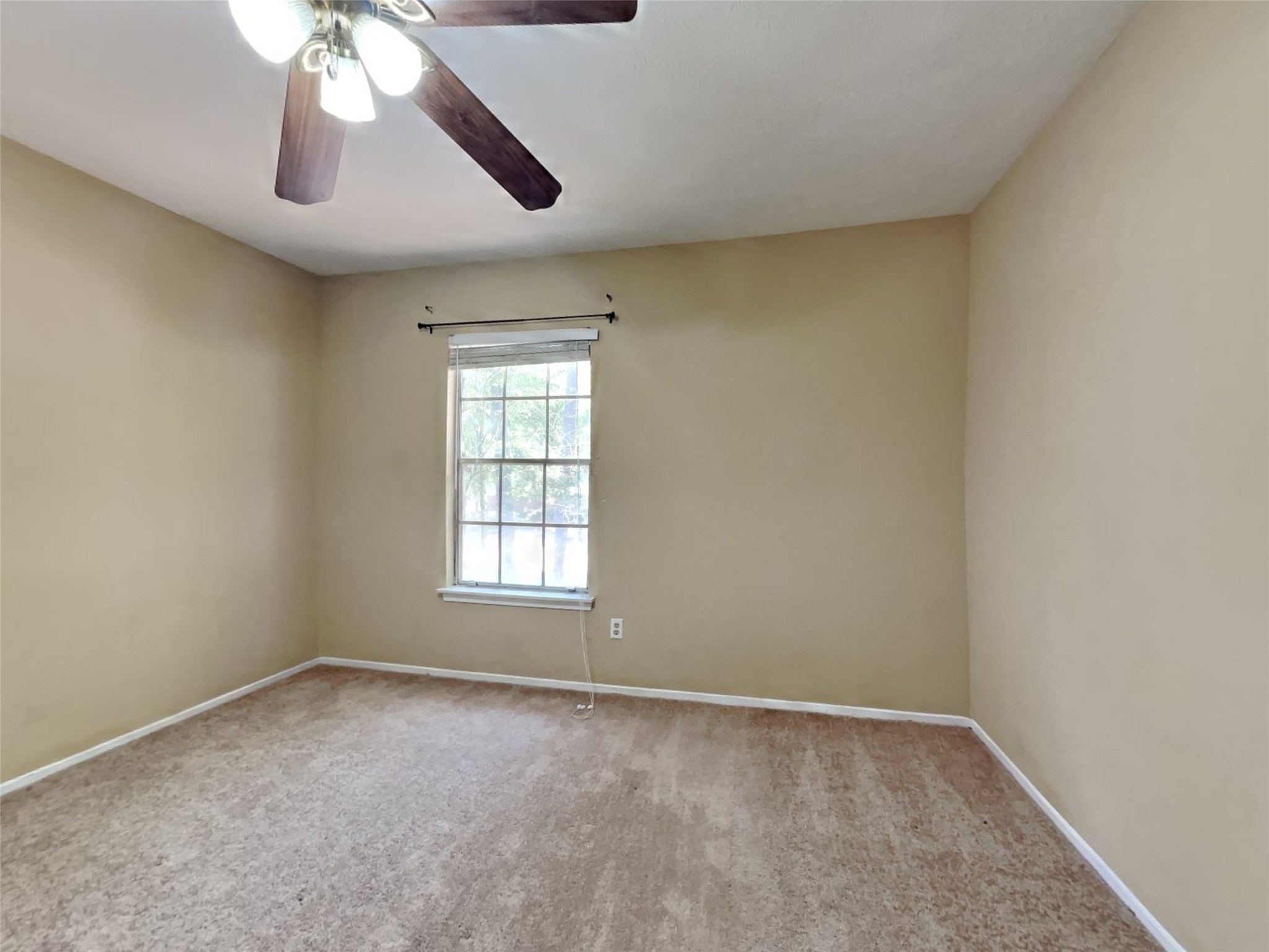 3910 Cedar Forest Drive Houston, TX 77339 - Photo 10 of 21 an empty room with windows and fan