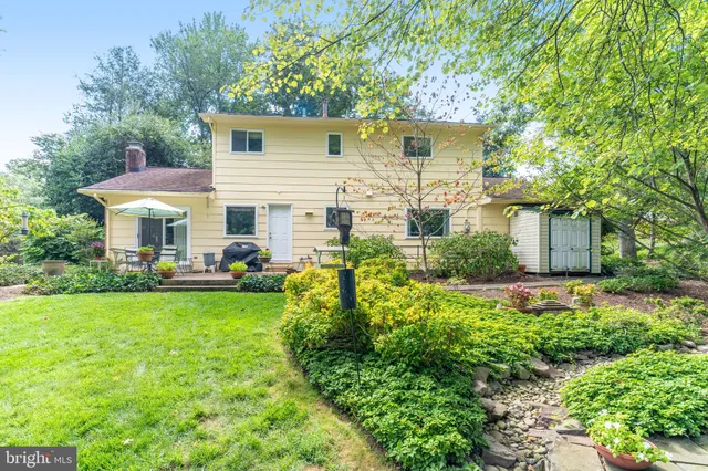 a view of a house with backyard sitting area and garden