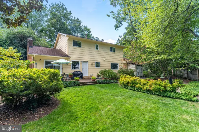 a front view of a house with a garden and plants