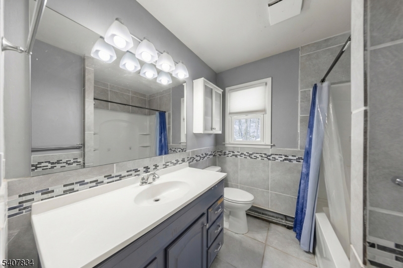 31 Meadow Lane Vernon, NJ 07462 - Photo 18 of 43 a bathroom with a sink and mirror with toilet