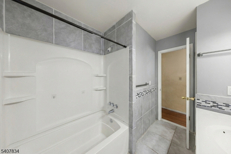 31 Meadow Lane Vernon, NJ 07462 - Photo 19 of 43 a bathroom with a bathtub and a shower