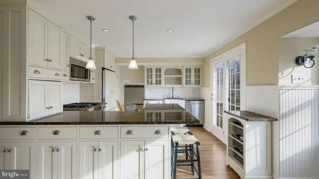a kitchen with stainless steel appliances granite countertop a sink and cabinets