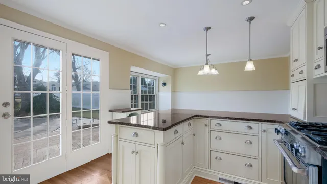 a kitchen with granite countertop a stove and a sink