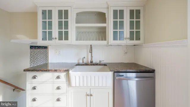 a kitchen with granite countertop wooden floors and center island