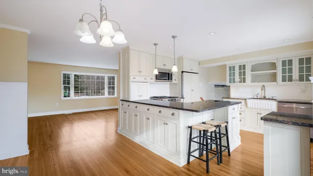 a living room with furniture a flat screen tv and a floor to ceiling window