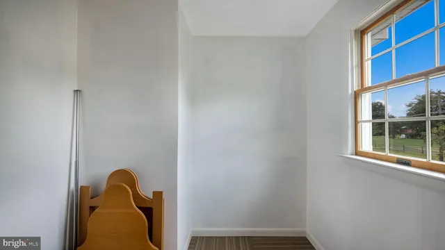 a bedroom with a bed a window and dresser