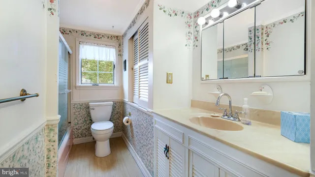 a white toilet sitting next to a window