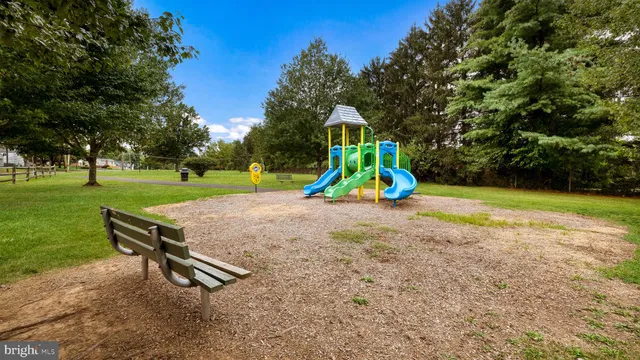 a view of a backyard with swimming pool and slide