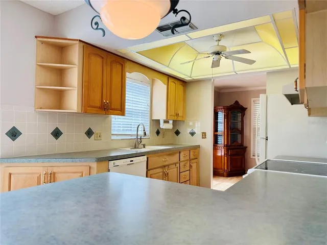 a view of a kitchen with a sink and cabinet