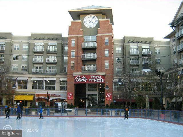 1300 South Arlington Ridge Road, Unit 309 Arlington, VA 22202 - Photo 13 of 14 a front view of a building with retail shops