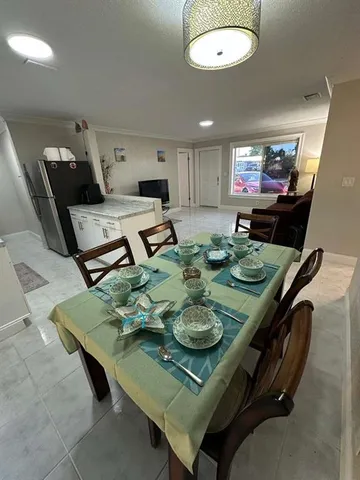 a living room with dining table and chairs