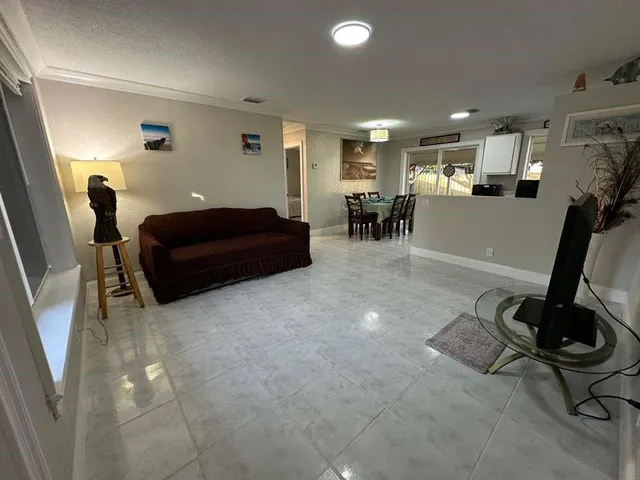 a living room with furniture gym equipment and a flat screen tv