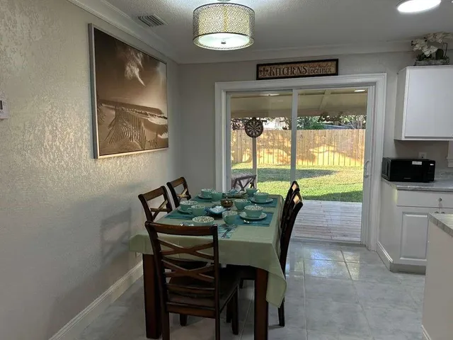 a view of a dining room with furniture window and outside view