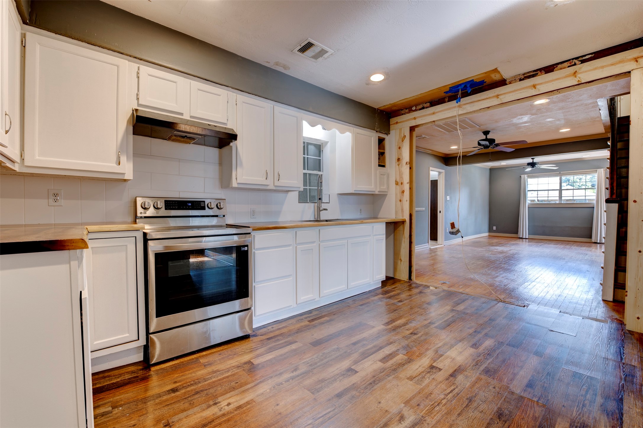 4303 Castor Street Houston, TX 77022 - Photo 11 of 41 a kitchen with stainless steel appliances granite countertop a stove a sink and a refrigerator