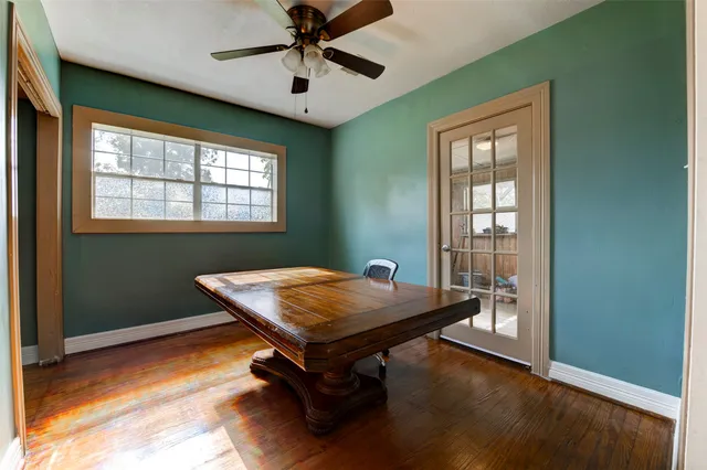 a room with pool table and windows