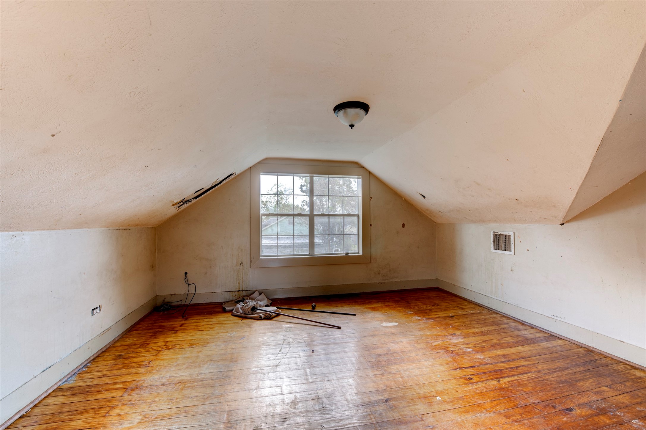 4303 Castor Street Houston, TX 77022 - Photo 20 of 41 an empty room with wooden floor and windows