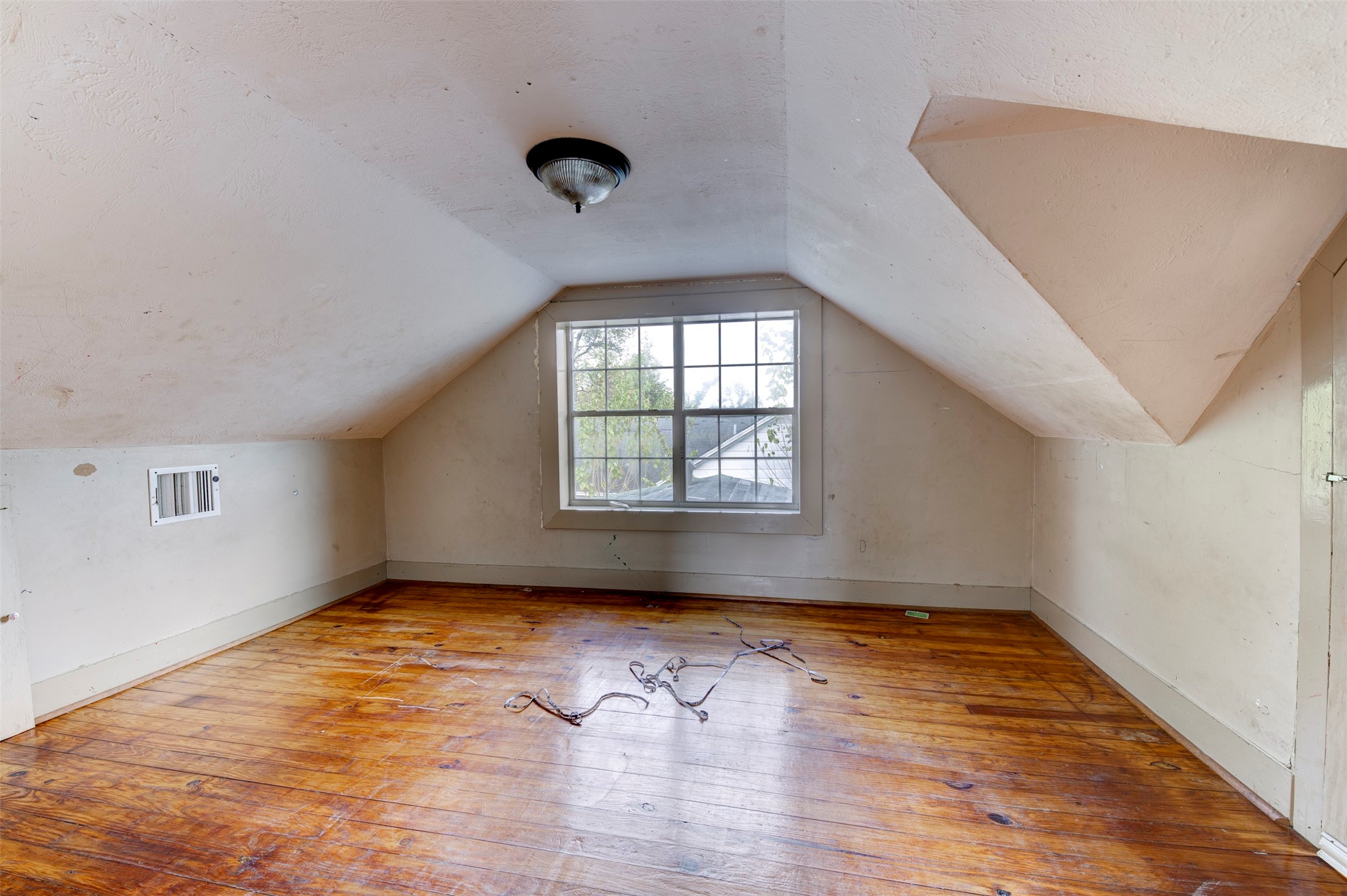 4303 Castor Street Houston, TX 77022 - Photo 21 of 41 an empty room with wooden floor and windows